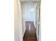 Long hallway featuring laminated floors, white walls, and access to multiple rooms at 2539 N 148Th Dr, Goodyear, AZ 85395
