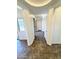 Bright hallway with tiled flooring, leading to various rooms with neutral wall paint at 2539 N 148Th Dr, Goodyear, AZ 85395