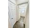 Tiled hallway with access to windowed room and storage at 2539 N 148Th Dr, Goodyear, AZ 85395