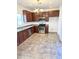 Spacious kitchen featuring stainless steel appliances, wood cabinetry, and tiled floors at 2539 N 148Th Dr, Goodyear, AZ 85395