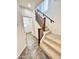 Carpeted staircase with wood railing and tiled landing at 2539 N 148Th Dr, Goodyear, AZ 85395