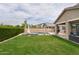 Spacious backyard with a well-kept lawn, outdoor seating, and a sparkling pool at 2854 E Virginia St, Mesa, AZ 85213