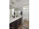 Bright bathroom with a white countertop, dark wood cabinets and tiled floors at 2854 E Virginia St, Mesa, AZ 85213