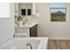 Bright bathroom featuring a soaking tub, a mountain view, and modern fixtures at 2854 E Virginia St, Mesa, AZ 85213