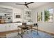 Well-lit home office with custom built-ins, a rustic desk, and large windows offering outdoor views at 2854 E Virginia St, Mesa, AZ 85213