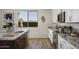 Bright kitchen featuring granite countertops, stainless steel appliances, and views of the outside landscape at 2854 E Virginia St, Mesa, AZ 85213