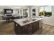 Open-concept kitchen with granite island, stainless steel appliances, and a view of the living area at 2854 E Virginia St, Mesa, AZ 85213