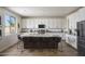 Modern kitchen with white cabinets, granite countertops, a large island, and stainless steel appliances at 2854 E Virginia St, Mesa, AZ 85213