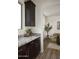 Stylish kitchenette with granite countertops, dark wood cabinets, and an open view to the dining room at 2854 E Virginia St, Mesa, AZ 85213