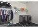 Efficient laundry room with modern washer and dryer, storage racks and dark tiled flooring at 2854 E Virginia St, Mesa, AZ 85213