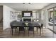 Open-concept living and dining area with modern furniture, a cozy fireplace, and ample natural light at 2854 E Virginia St, Mesa, AZ 85213