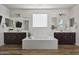 Luxurious main bathroom with dual vanities, soaking tub, and modern fixtures at 2854 E Virginia St, Mesa, AZ 85213