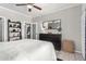 A modern style bedroom featuring wood floors, a gray wall, and neutral decor at 29606 N Tatum Blvd # 245, Cave Creek, AZ 85331