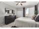 Well lit bedroom with a neutral color scheme, light floors, a dark dresser, and a window at 29606 N Tatum Blvd # 245, Cave Creek, AZ 85331