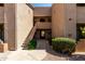 Exterior view of apartment building with staircase and well-maintained landscaping at 29606 N Tatum Blvd # 245, Cave Creek, AZ 85331