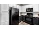 Efficient kitchen features black and white cabinets, modern appliances, and ample counter space at 29606 N Tatum Blvd # 245, Cave Creek, AZ 85331