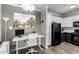 Contemporary office area featuring a desk, modern lighting, and views into the kitchen at 29606 N Tatum Blvd # 245, Cave Creek, AZ 85331