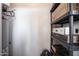 Small storage room with a water heater, storage shelving, and miscellaneous home items at 29606 N Tatum Blvd # 245, Cave Creek, AZ 85331