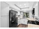 Modern kitchen featuring stainless steel fridge, white cabinets, stone countertops, and stainless steel appliances at 347 Leisure World --, Mesa, AZ 85206