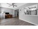 Open living room featuring gray walls, wood-look flooring, a ceiling fan, and a pass-through to the kitchen at 347 Leisure World --, Mesa, AZ 85206