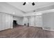 Bright living area featuring wood-look flooring, neutral walls, a ceiling fan, and plenty of closet space at 347 Leisure World --, Mesa, AZ 85206