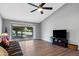 Modern living room area with wood-look floors, neutral walls, a ceiling fan, and access to the backyard at 347 Leisure World --, Mesa, AZ 85206