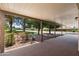Spacious covered patio with a view of the well-manicured yard and a glimpse of the neighborhood at 347 Leisure World --, Mesa, AZ 85206