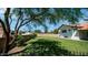 Grassy backyard with a view of the house showing fence and foliage at 35 E Secretariat Dr, Tempe, AZ 85284