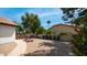 Backyard with block fencing, gravel, greenery and a variety of necessities and toys at 35 E Secretariat Dr, Tempe, AZ 85284