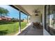 Spacious covered patio with ceiling fan and dining table, overlooking the lush backyard at 35 E Secretariat Dr, Tempe, AZ 85284