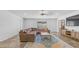Finished basement featuring a brown sectional, wooden stairs, and tiled floors at 35 E Secretariat Dr, Tempe, AZ 85284