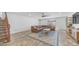 Spacious basement living area with a brown sectional, wooden stairs, and area rug at 35 E Secretariat Dr, Tempe, AZ 85284