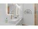 Bathroom featuring double vanity with marble counters, white subway tiles, and gold fixtures at 35 E Secretariat Dr, Tempe, AZ 85284