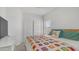 Cozy bedroom with bright, colorful quilt and natural light from the window at 35 E Secretariat Dr, Tempe, AZ 85284