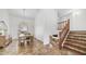 Dining room with wooden table and chandelier, adjacent to wooden staircase at 35 E Secretariat Dr, Tempe, AZ 85284
