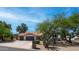Charming single-Gathering home featuring a terracotta roof, three-car garage, desert landscaping, and a stone-accented facade at 35 E Secretariat Dr, Tempe, AZ 85284