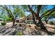 Beautiful single-story home with manicured landscaping, stone accents, and a terracotta tile roof, framed by mature trees at 35 E Secretariat Dr, Tempe, AZ 85284