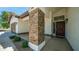 Inviting front entrance with decorative stone column, covered porch, and well-manicured landscaping at 35 E Secretariat Dr, Tempe, AZ 85284