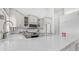 Modern kitchen featuring white cabinets, stainless steel appliances, marble countertops, and designer fixtures at 35 E Secretariat Dr, Tempe, AZ 85284