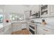 Bright, updated kitchen with white cabinets, marble countertops, modern appliances, and a view of the backyard at 35 E Secretariat Dr, Tempe, AZ 85284