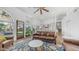 Bright living room with brown leather furniture, ceiling fan, and outdoor access at 35 E Secretariat Dr, Tempe, AZ 85284