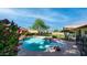Inviting backyard pool featuring a rock waterfall, lush landscaping, and a private setting at 35 E Secretariat Dr, Tempe, AZ 85284
