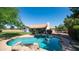 Backyard view showcasing the pool, lush landscaping, and the home's exterior at 35 E Secretariat Dr, Tempe, AZ 85284