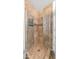 Tiled shower with glass doors and decorative tile accents at 35 E Secretariat Dr, Tempe, AZ 85284