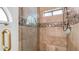 Detailed shower with tiled walls, mosaic accents, glass door, and gold handle at 35 E Secretariat Dr, Tempe, AZ 85284
