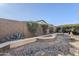 Beautiful backyard features a stone-accented sitting area surrounded by lush desert landscaping at 3649 E Hazeltine Way, Chandler, AZ 85249