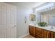 This bathroom features double sinks, a framed mirror, vanity lighting, and safety bars at 3649 E Hazeltine Way, Chandler, AZ 85249