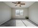 The bedroom has neutral colored walls and carpeting, a ceiling fan, and a bright window view at 3649 E Hazeltine Way, Chandler, AZ 85249