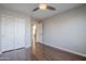 This bedroom showcases hardwood floors, a ceiling fan, a closet, and a doorway leading to another room at 3649 E Hazeltine Way, Chandler, AZ 85249