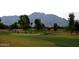 Golf course with lush green fairways, sand traps, and players enjoying a round of golf with mountain views at 3649 E Hazeltine Way, Chandler, AZ 85249